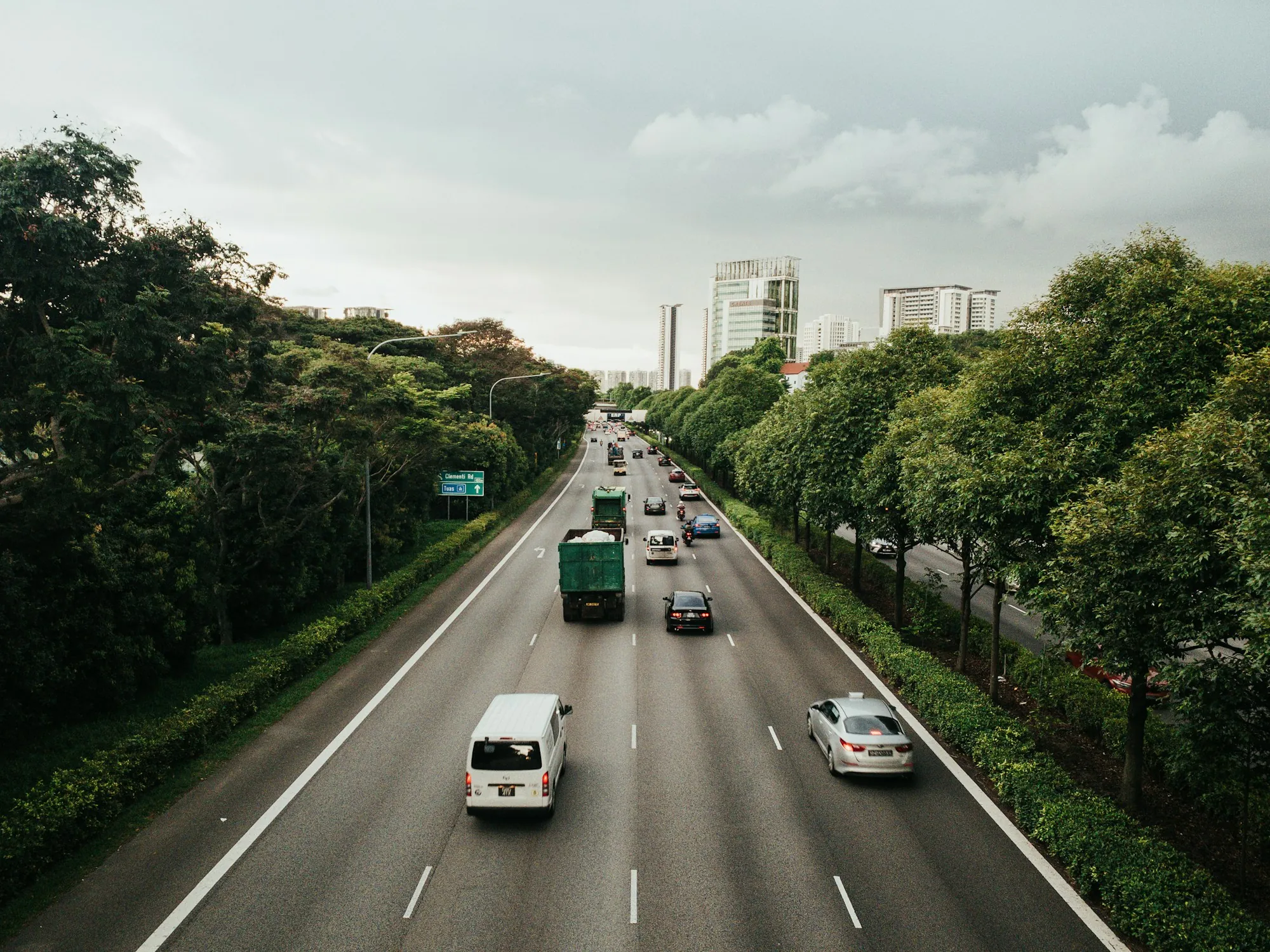 Tree-lined highway with light traffic in both directions